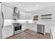 Bright kitchen with white cabinets, stainless steel appliances, and hardwood floors at 3987 Tamarack Nw Dr, Kennesaw, GA 30152