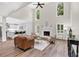 Open-concept living room boasting high ceilings, large windows, a fireplace, and seamless flow to the kitchen at 3987 Tamarack Nw Dr, Kennesaw, GA 30152