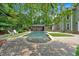 Backyard showcasing a pool with chairs, green grass, stone, surrounding lush trees and the home's exterior at 3987 Tamarack Nw Dr, Kennesaw, GA 30152