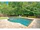A beautiful in-ground pool features a stone surround and is nestled in a private backyard with mature trees at 3987 Tamarack Nw Dr, Kennesaw, GA 30152