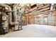 Unfinished basement with exposed ceiling, insulated walls, and a water heater ready for customization at 1489 Belmont Hills Dr, Suwanee, GA 30024