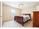Cozy bedroom with neutral walls, plush carpeting, and a colorful ceiling fan for a vibrant touch at 1489 Belmont Hills Dr, Suwanee, GA 30024