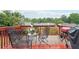 Relaxing outdoor deck with furniture and views of the surrounding trees at 1489 Belmont Hills Dr, Suwanee, GA 30024