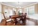 Formal dining room featuring hardwood floors, a chandelier and decorative trim throughout at 1489 Belmont Hills Dr, Suwanee, GA 30024
