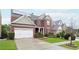 Beautiful two-story brick home in a residential neighborhood with a manicured lawn and solar panels at 1489 Belmont Hills Dr, Suwanee, GA 30024