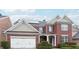 Elegant brick two-story home featuring a two-car garage and neatly manicured landscaping at 1489 Belmont Hills Dr, Suwanee, GA 30024