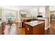 Bright, open kitchen with wood cabinets, granite countertops, a central island, and an eat-in area at 1489 Belmont Hills Dr, Suwanee, GA 30024