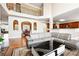 Open-concept living area with hardwood floors, a fireplace, and abundant natural light at 1489 Belmont Hills Dr, Suwanee, GA 30024