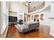 Open-concept living room featuring a fireplace, hardwood floors, and large windows at 1489 Belmont Hills Dr, Suwanee, GA 30024