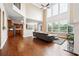 Bright living room with hardwood floors, a soaring ceiling, and large windows at 1489 Belmont Hills Dr, Suwanee, GA 30024