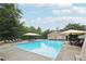 Community pool with lounge chairs and umbrellas, perfect for relaxing and enjoying sunny days at 1489 Belmont Hills Dr, Suwanee, GA 30024