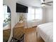 Bright bedroom featuring hardwood floors, dresser, and natural light creating a relaxing atmosphere at 300 Peachtree Ne St # 14H, Atlanta, GA 30308