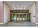 The entrance to Peachtree Towers features a glass entryway and silver handrails at 300 Peachtree Ne St # 14H, Atlanta, GA 30308