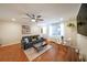 Bright living room featuring hardwood floors, comfortable seating, and modern ceiling fan for added comfort at 300 Peachtree Ne St # 14H, Atlanta, GA 30308