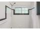 Updated bathroom featuring white tiling, modern showerhead, and window at 311 Peachtree Hills Ne Ave # 13B, Atlanta, GA 30305