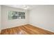 Bright bedroom features hardwood floors and a large window for plenty of natural light at 311 Peachtree Hills Ne Ave # 13B, Atlanta, GA 30305