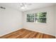 Bright bedroom featuring hardwood floors, a ceiling fan, and a sunlit window at 311 Peachtree Hills Ne Ave # 13B, Atlanta, GA 30305