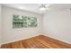 Bright bedroom with hardwood floors, large window, and ceiling fan at 311 Peachtree Hills Ne Ave # 13B, Atlanta, GA 30305