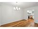 Dining room with hardwood floors, chandelier, and adjacent kitchen at 311 Peachtree Hills Ne Ave # 13B, Atlanta, GA 30305
