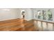 Cozy living room showcasing hardwood floors, access to the kitchen, and a door to the balcony at 311 Peachtree Hills Ne Ave # 13B, Atlanta, GA 30305