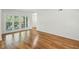 Bright living room with hardwood floors and glass doors leading to the balcony at 311 Peachtree Hills Ne Ave # 13B, Atlanta, GA 30305