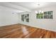 Living room featuring hardwood floors, natural light, and a stylish chandelier at 311 Peachtree Hills Ne Ave # 13B, Atlanta, GA 30305