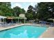 Inviting community pool surrounded by comfortable lounge chairs and lush greenery at 311 Peachtree Hills Ne Ave # 13B, Atlanta, GA 30305