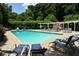 Beautiful community pool area with lounge chairs and a covered pergola at 311 Peachtree Hills Ne Ave # 13B, Atlanta, GA 30305