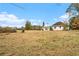 Backyard view of the home with a large grass area surrounded by trees at 6219 Heardsville Rd, Cumming, GA 30028