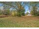 Large backyard with mature trees and foliage surrounding the home at 6219 Heardsville Rd, Cumming, GA 30028