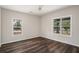 Inviting bedroom featuring dark wood floors and great natural light from dual windows, creating a comfy space at 6219 Heardsville Rd, Cumming, GA 30028