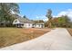 Spacious property showcasing a long driveway leading to a charming home with an attached garage at 6219 Heardsville Rd, Cumming, GA 30028