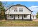 Charming two-story home with a black porch and white siding, offering a blend of modern and traditional style at 6219 Heardsville Rd, Cumming, GA 30028