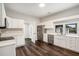 Modern kitchen with white cabinets, stainless steel appliances, and dark wood floors for a sleek design at 6219 Heardsville Rd, Cumming, GA 30028