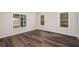 Bright living room with dark wood floors and natural light from the windows, creating a cozy space at 6219 Heardsville Rd, Cumming, GA 30028