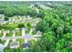 An aerial view of a suburban neighborhood showcases homes with lush trees and a well-maintained community at 6561 Squire Pl, Douglasville, GA 30135