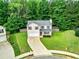 Aerial shot of a two-story home with a well-manicured lawn and a driveway leading to a cul-de-sac at 6561 Squire Pl, Douglasville, GA 30135