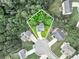 A bird's-eye view of a home in a quiet cul-de-sac, surrounded by lush greenery and other well-maintained homes at 6561 Squire Pl, Douglasville, GA 30135
