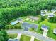 An aerial view of the community pool, tennis courts, playground, parking, and mature trees at 6561 Squire Pl, Douglasville, GA 30135