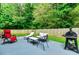 Backyard patio area with multiple seating areas and green foliage at 6561 Squire Pl, Douglasville, GA 30135