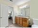 Bathroom includes a wood vanity with granite countertop and sink plus white cabinets at 6561 Squire Pl, Douglasville, GA 30135