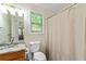 Full bathroom with vanity sink, toilet, and tiled shower at 6561 Squire Pl, Douglasville, GA 30135
