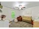 Bedroom room with wood crib, chair, and nature-themed wall decor at 6561 Squire Pl, Douglasville, GA 30135