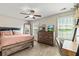 Bedroom with wood bed, dresser, two windows, wood shelves and desk at 6561 Squire Pl, Douglasville, GA 30135