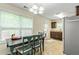 Sunlit dining area with tiled flooring and a view to the backyard at 6561 Squire Pl, Douglasville, GA 30135