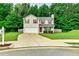 Charming two-story home features a lush green lawn, driveway, and attached garage at 6561 Squire Pl, Douglasville, GA 30135