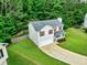 Aerial view of home with attached garage, cozy front porch, and fenced-in backyard at 6561 Squire Pl, Douglasville, GA 30135
