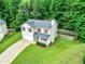 Aerial view of home with attached garage, cozy front porch, and fenced-in backyard at 6561 Squire Pl, Douglasville, GA 30135