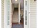 Bright foyer with wood floors, staircase, and a glimpse into the dining area at 6561 Squire Pl, Douglasville, GA 30135