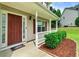 Inviting front porch with a neatly landscaped garden bed and a welcoming entrance at 6561 Squire Pl, Douglasville, GA 30135